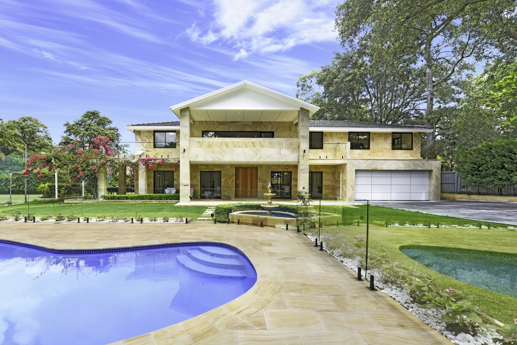 Sandstone residence beside a swimming pool